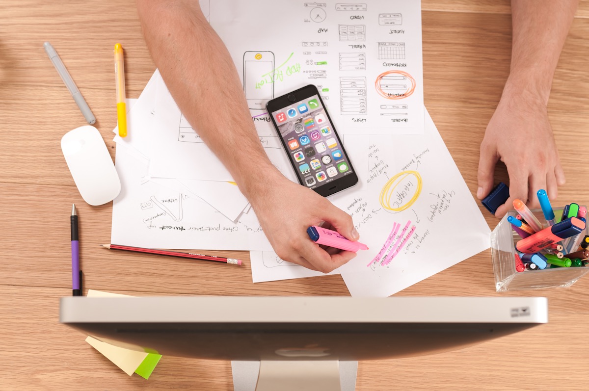 Design notes and wireframes on the desk